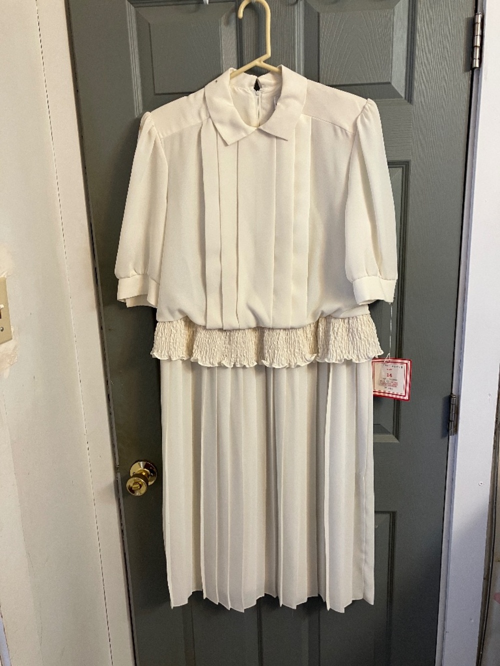 Ivory pleated one piece dress by Kevin Stuart